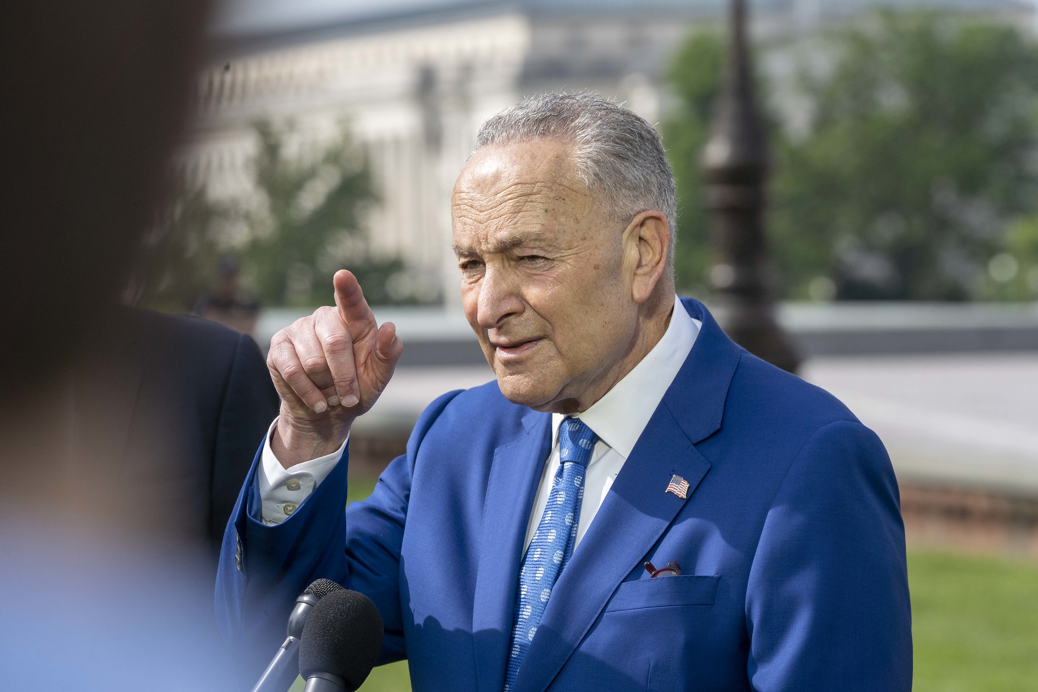 Senate Majority Leader Chuck Schumer (D-N.Y.) speaks outside.